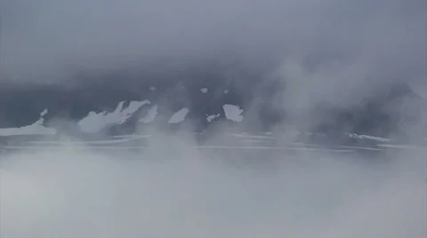 Moving clouds framing a snowy slope in the Icelandic fjords Stock Footage 37269759