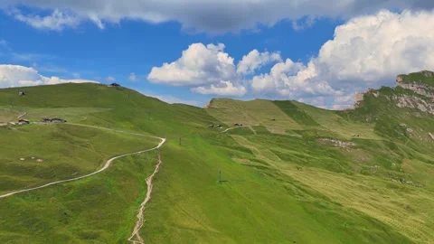 Moving clouds gracefully drift over a lush green mountain pass Stock Footage 285085748