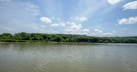 Moving clouds next to a lake Stock Footage 83910976