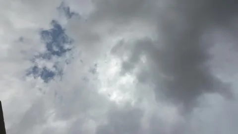 Moving Clouds Over Blue Sky Timelapse Video in Front Of The Sun During The Day Stock Footage 288063706