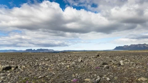 Moving clouds over a deserted volcanic landscape on a sunny summer day Video stock 136978172