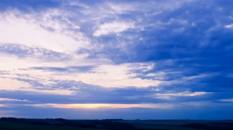 Moving clouds over field an sunset, time lapse Stock Footage 41233519