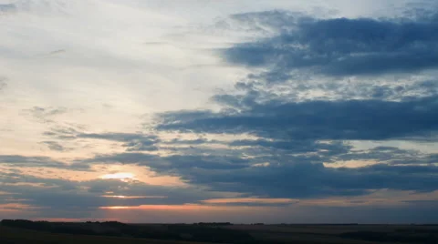 Moving clouds over field an sunset, timelapse Stock Footage 41233648