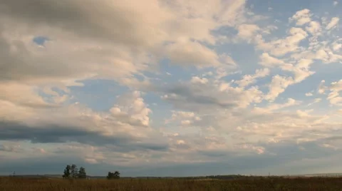 Moving clouds over field an sunset, time lapse. Stock Footage 46730630