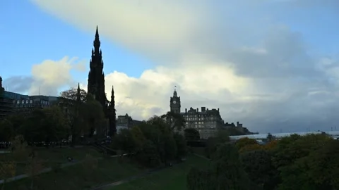 Moving clouds over the Princes Street Gardens at sunset Stock Footage 289144313