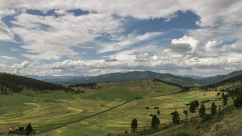 Moving clouds over a valley Video stock 154932470