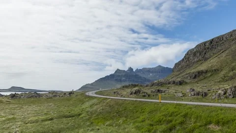 Moving clouds over a winding coastal road in Iceland on a summer day Video stock 136978296