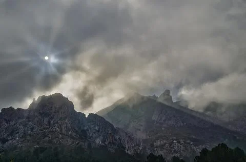 Moving clouds in the peaks Stock Photos