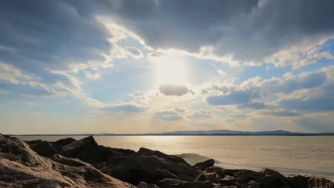 Moving clouds in the rays of the bright sun at sunset. Time lapse. Stock Footage 238527022