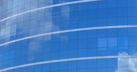 Moving clouds in reflective office windows - timelapse video Stock Footage
