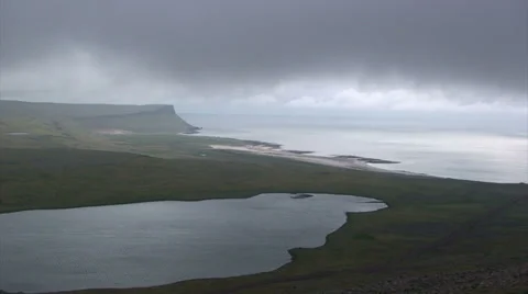 Moving clouds on wide ocean bay with lake in foreground Stock Footage 37301921