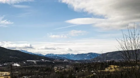 Moving cloudscape over mountain region town Stock Footage 62019431