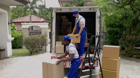 Moving company employee is unloading things from a truck to bring Stock Footage 229484349