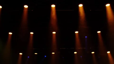Moving concert spotlights create dynamic warm lighting effects on stage in .. Stock Footage 330306801