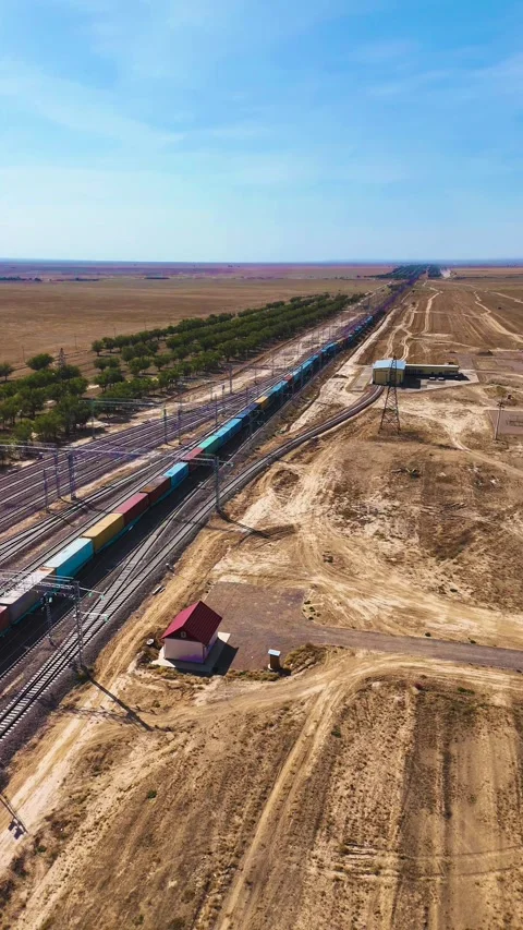 Moving Container Train Through Electrified Railway Tracks in Steppe Stock Footage 346320891