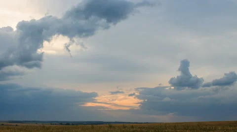 Moving cumulus clouds over field an sunset. Stock Footage 46730640