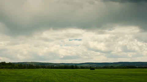 Moving cumulus clouds over green field. Stock Footage 42870099
