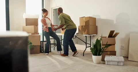 Moving, dancing and couple with smile in new home, relocation or property Stockbeeldmateriaal 336775639