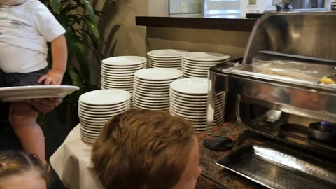 Moving down breakfast buffet line people serving Stock-Footage 94237648