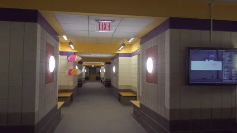 Moving down empty university hall to economics class Stock Footage