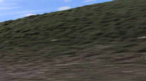 Moving down the highway with mountains in the background. Stock Footage 23164592