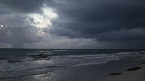 Moving down on view of dramatic clouds over a Western Australian beach 6K Stock Footage 313643316