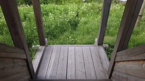 Moving down on wooden steps. view from porch to the field Stock Footage 134732548
