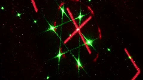 Moving drawings with rays of light of green and red colors on a black background Stock Footage 305020225