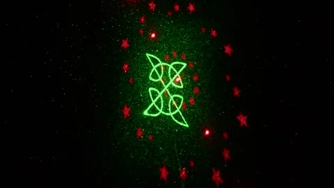 Moving drawings with rays of light of green and red colors on a black background Stock Footage 305020244