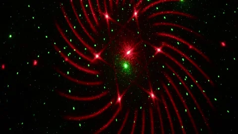 Moving drawings with rays of light of green and red colors on a black background Stock Footage 305020316