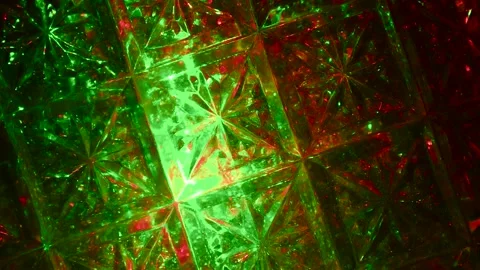 Moving drawings with rays of light of green and red colors on a black background 動画素材 305020451