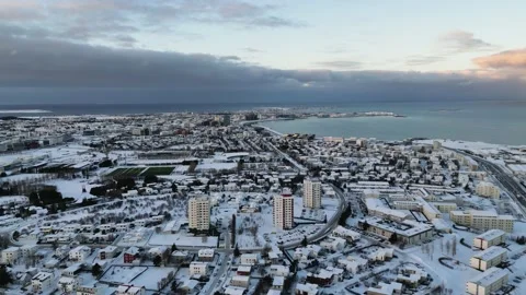 Moving drone camera view to Iceland's capital. Snow covered Reykjavik. Fjords Stock Footage 235540956