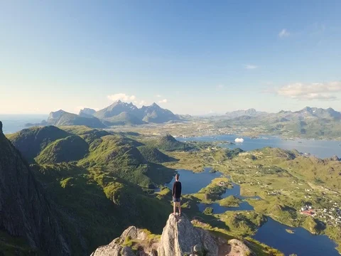Moving Drone shot of man overlooking Norway's mountain landscape Stock Footage