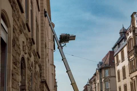 Moving elevator with ladder on the fifth floor in the city. Stock Photos