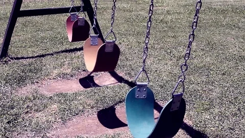 Moving empty swings in park close up, ghost creepy concept Stock Footage 107170019