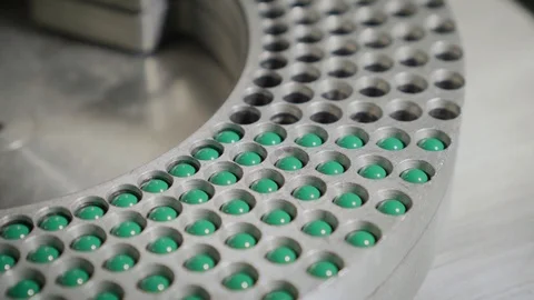 Moving equipment with blue-green hard shelled capsules Stock Footage 102456207
