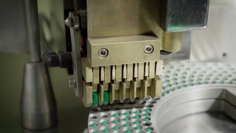 Moving equipment with blue-green hard shelled capsules Stock Footage 102456313