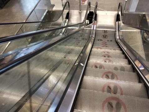 Moving escalator downwards Stock Photos