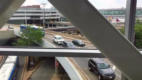 Moving escalator going past traffic at Boston Logan Airport Stock Footage