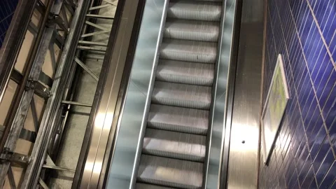 Moving escalator next to a dismantled elevator inside a building Stock Footage 133656769