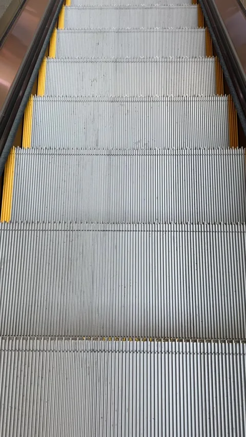 Moving escalator steps going up in modern indoor public building Stock Footage 320018104