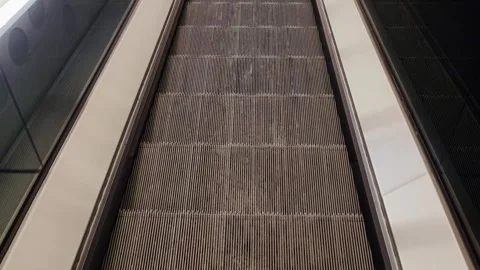 Moving escalator steps in a modern indoor setting Stock Footage 341109551