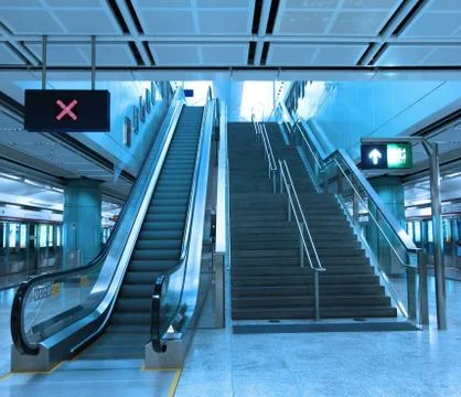 Moving escalator in train station Stock Photos