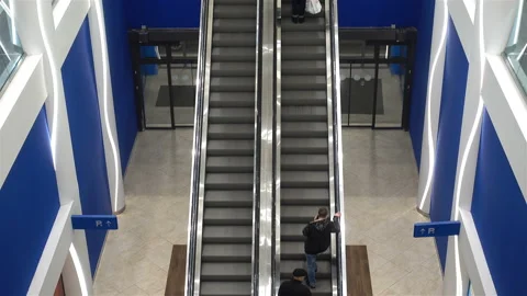 Moving escalators with people in 4K. Video stock 129333382