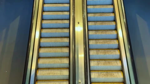 Moving escalators in a public place with one side not in use during the day Stock Footage 332047177