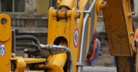 Moving Excavator Scoop Close Up Workers Men in Orange Workwear And Helmets Stock Footage 54328137