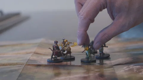 Moving fantasy miniatures on map, rolling dice Stock Footage 114557050