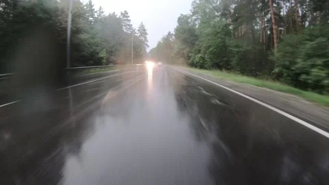 Moving fast forward on the wet rainy asphalt road. Stock Footage 145489944