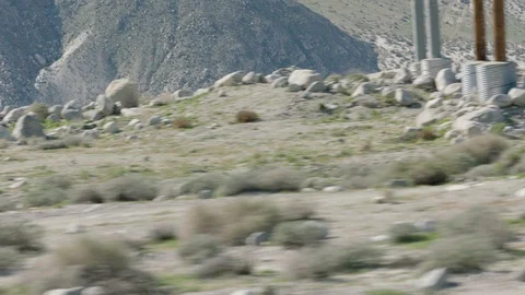 Moving fast by windmills in a desert Stock Footage 106473650