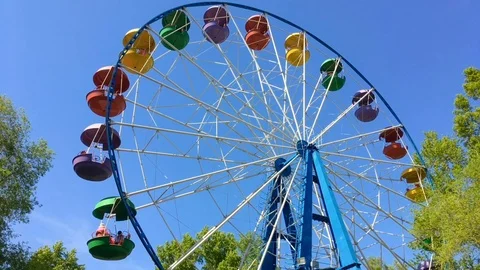 Moving ferris wheel on the blue sky background. Stock Footage 109075934